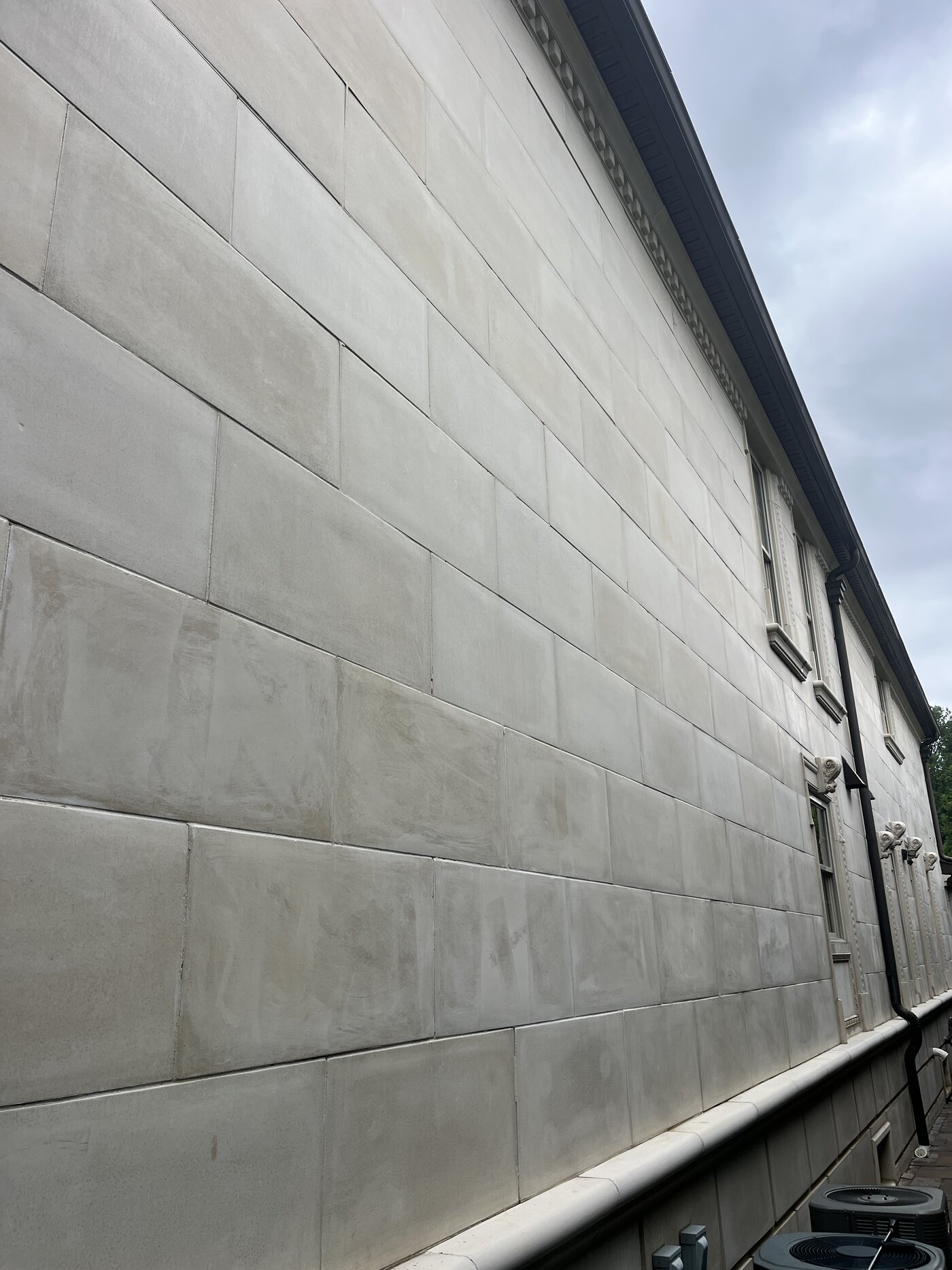 Long run of clean, evenly toned limestone wall after soft washing