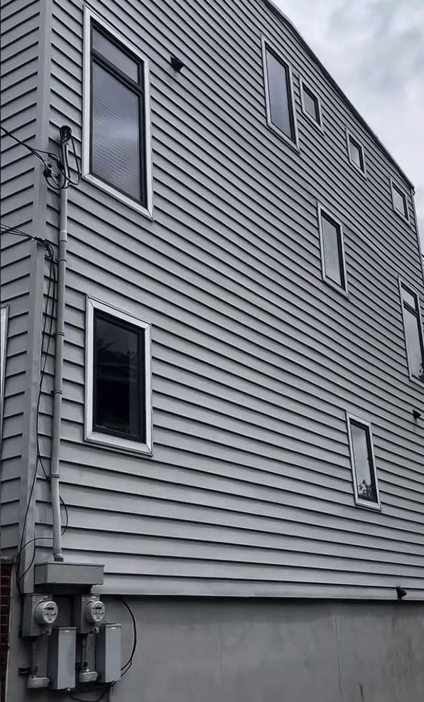 The tall side elevation of the Jersey City Heights home before washing