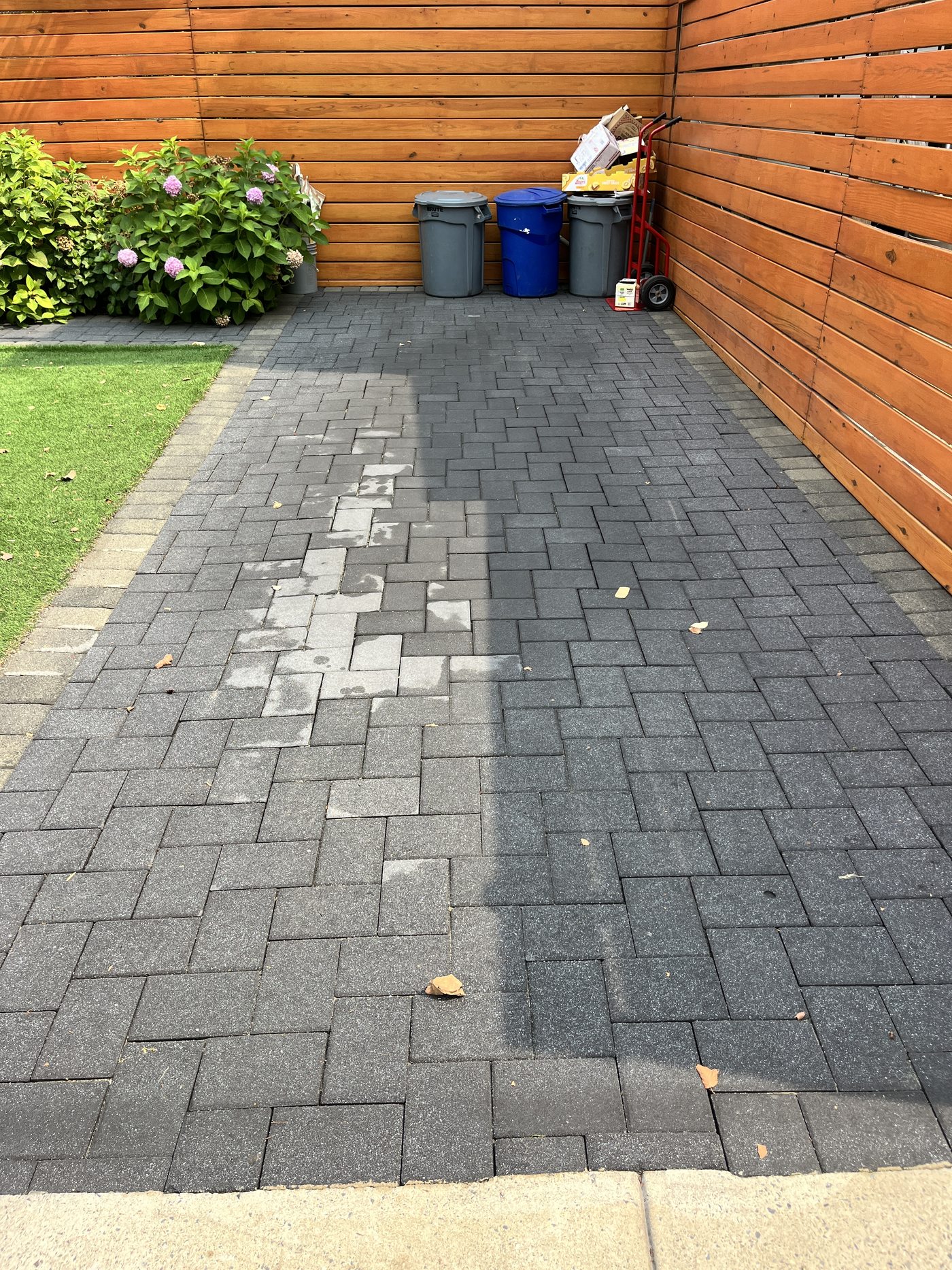 Charcoal paver patio mid-clean in Jersey City, NJ