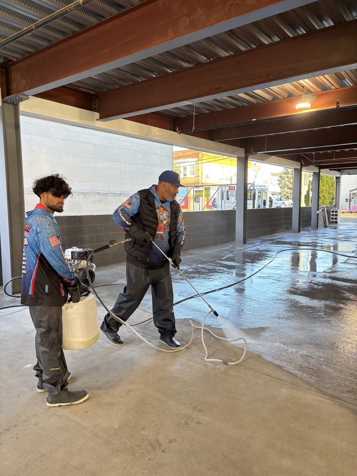 Premier Power Washerz crew surface cleaning a commercial garage floor